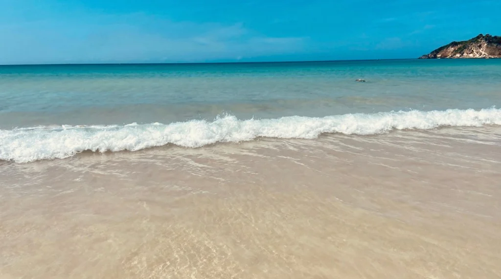 Turquoise waves reaching the shore at Playa Macao in Punta Cana