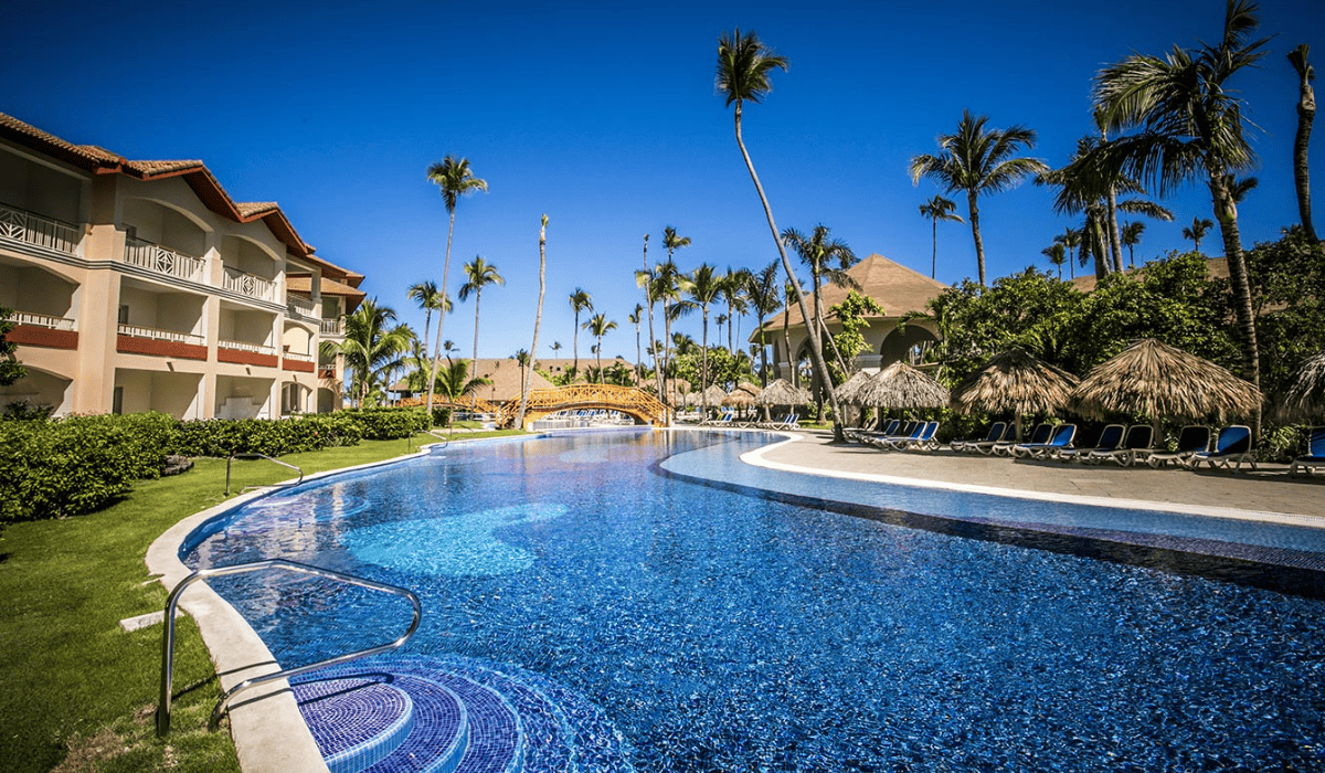 resort with a big pool and a building in Majestic Colonial Punta Cana