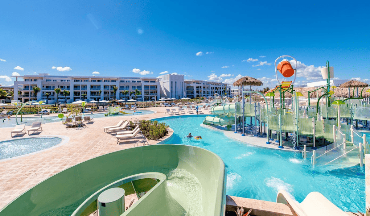 The Falcon's Resort by Melia featuring a waterslide, pool, and loungers.