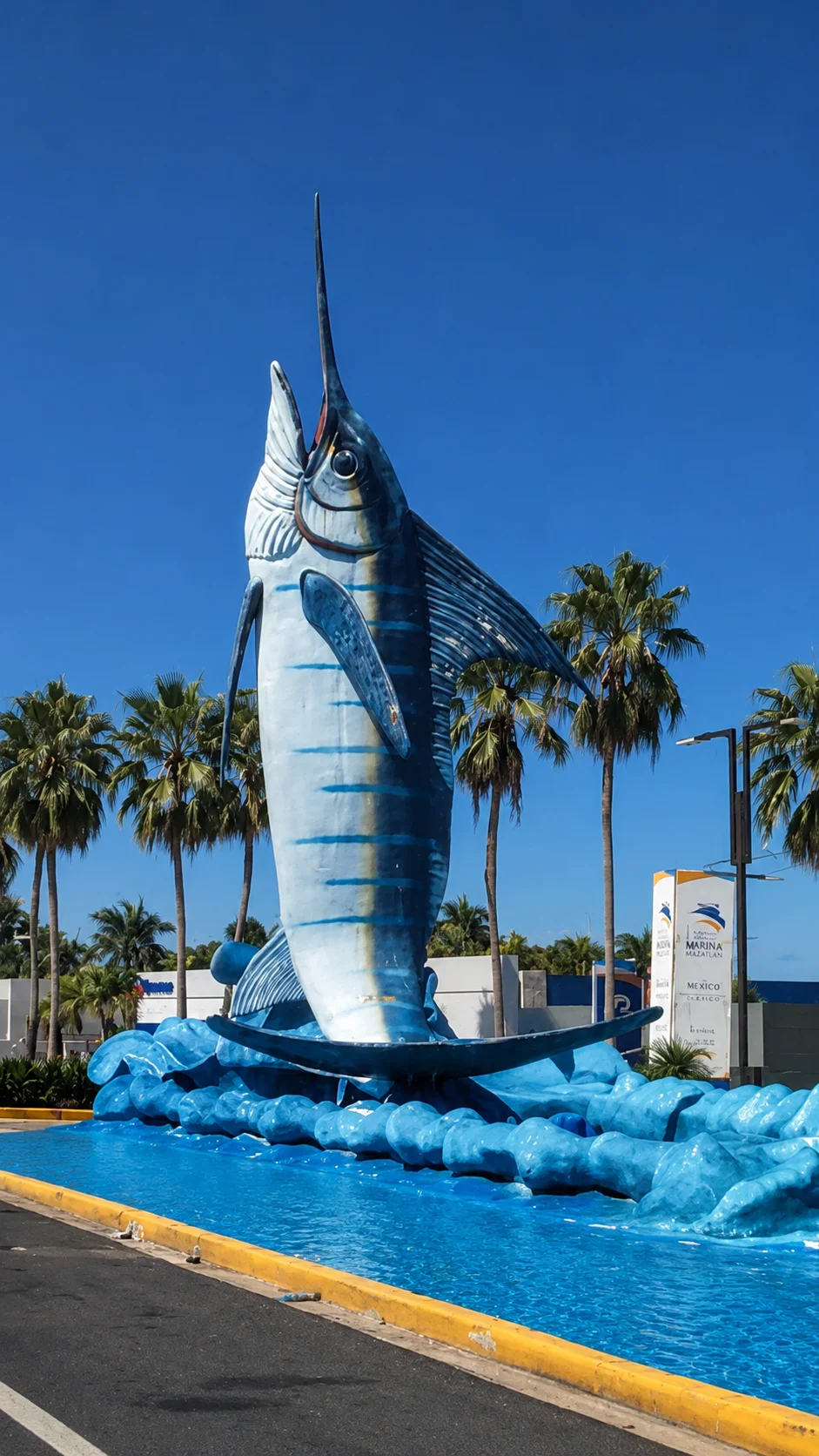 Giant blue marlin sculpture marking a shopping center entrance